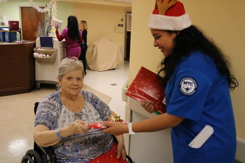 PCT-student-Iyya-Arjona-Ulloa-giving-gifts-to-BayVue-resident-Marilyn-Schragl-2
