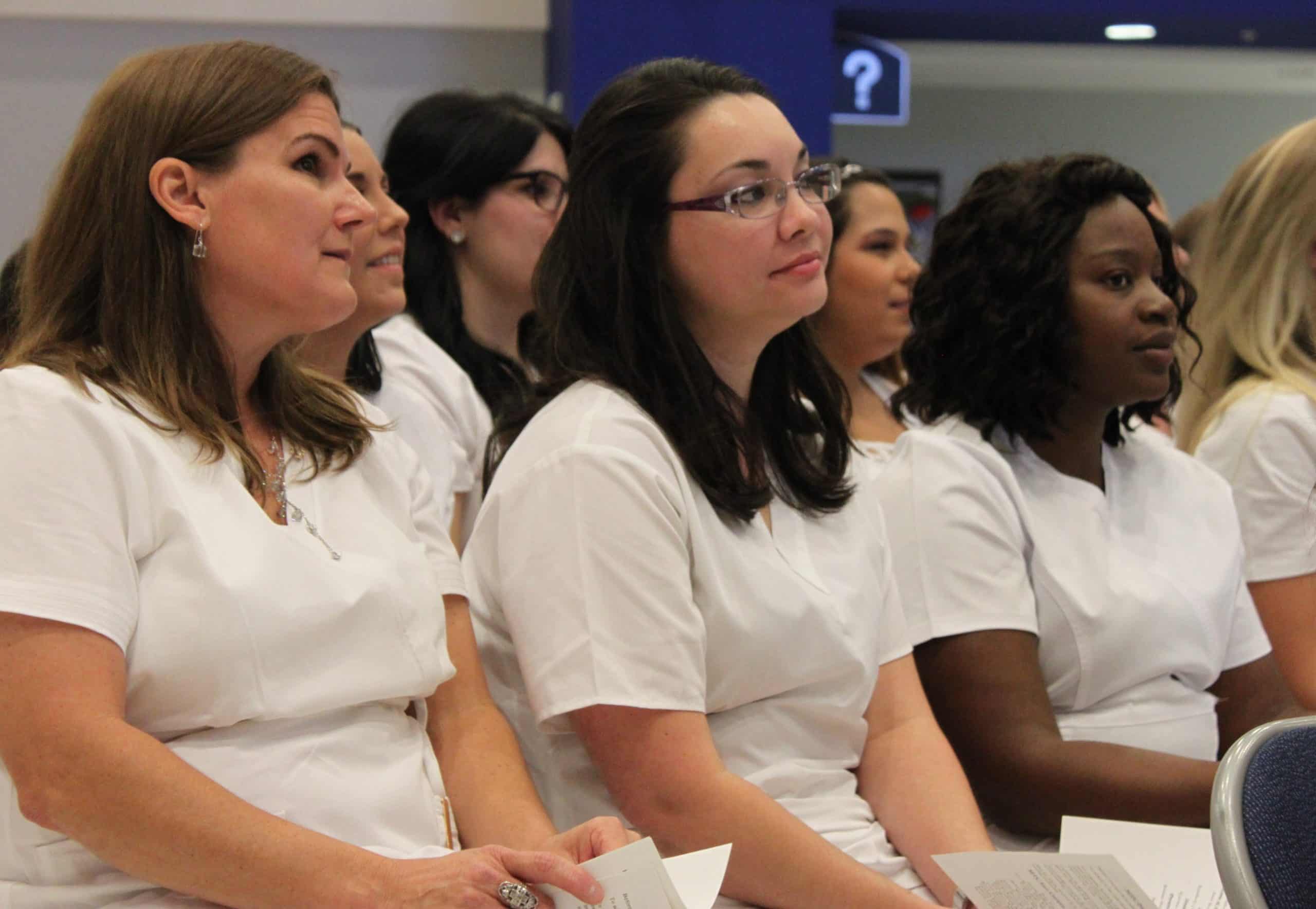 PN grads June Sturdy Sarah Delke Bona Hallmon listen to speaker